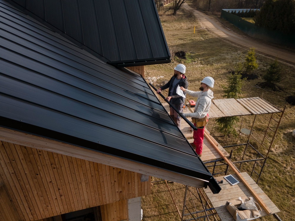 Two-person Summit Roofing crew installing a roof replacement in Denver